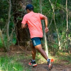 a man running in the woods on a trail