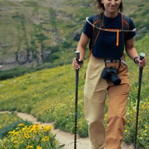A woman hiking up a trail in the mountains